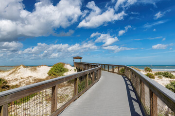 Smyrna Dunes Park with elevated boardwalk and fishing pier in New Smyrna Beach, Florida.