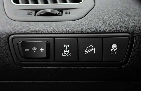 Isolated 4wd button on dashboard. Driver Knee Pad Panel modern car. Car Hud Switch. ESP off Switch. Car light switch. Control buttons combination Details. dimming light button.