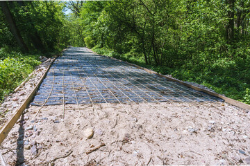Construction of roads. Construction of bicycle paths. Creating a sidewalk in the forest. Formwork sidewalk.