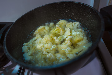 Boiling cauliflower in a pot. Cooking healthy food