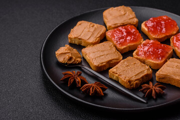 Delicious nutritious sandwiches with peanut butter, strawberry jam