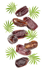 flying fresh date fruits with green leaves isolated on white background. clipping path