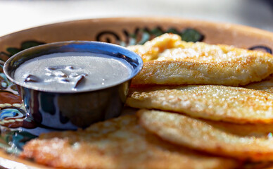 Fresh fried potato fritters with delicious mushroom sauce. Food establishments, cafes and restaurants, menus and serving. Tasty and healthy food