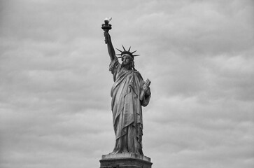 Statue of Liberty on the background of sky, New York City. Black and white image.