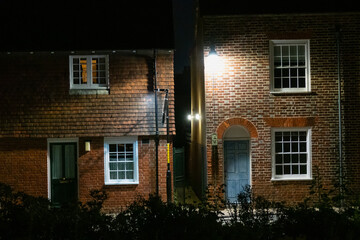 Beauty of the old terraced brick houses illuminated by street lamps at night
