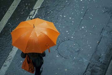 Urban Solitude Under an Orange Canopy - A solitary figure finds solace under the shield of a vivid orange umbrella amidst the city's rain-soaked streets, a beacon of warmth in the cool, wet weather.