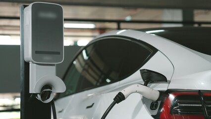 EV electric car recharge at shopping center multistorey indoor parking lot charging in downtown...