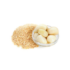 Heap of dehydrated garlic granules and peeled cloves isolated on white