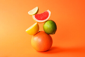 Fresh ripe citrus fruits on orange background