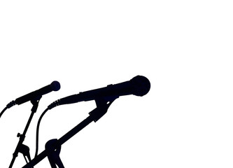 Silhouette of two microphones on stands isolated on a white background. No people. Music and...