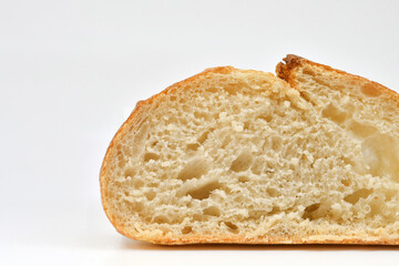 Slice of fresh sourdough bread on a plain white background. Copy space.