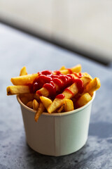 Chips Served in a Paper Bowl, Topped with a Drizzle of Tangy Ketchup for an Irresistible Snack