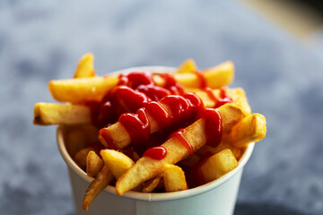 Chips Served in a Paper Bowl, Topped with a Drizzle of Tangy Ketchup for an Irresistible Snack