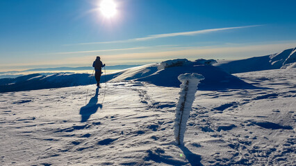 Man in snowshoes on snow covered mountains of Kor Alps, Lavanttal Alps, Carinthia Styria, Austria....