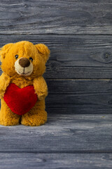 Teddy bear with a heart, vintage tone, concept of love, Valentine's Day holiday. Mothers Day