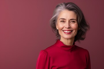 Radiant Mature Woman with Elegant Gray Hairstyle and Red Top Smiling.