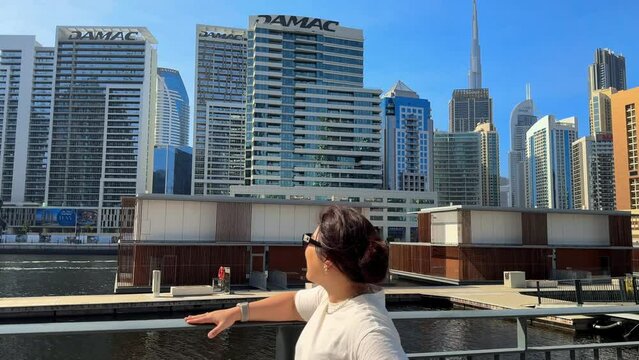Portrait of smiling woman looking up on great modern buildings megapolis. Attractive female exploring city on summer weekend close up. Gorgeous model posing in stylish clothes standing on street. High