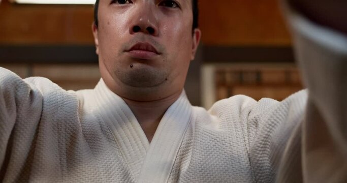 Aikido, student and practice martial arts, fight and pov of class in traditional gym. Japanese, fighter and man in competition with self defence, skill and learning action of fighting gesture
