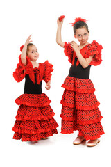 Two little girls in a red Spanish dress dance flamenco. Purim