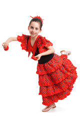 A little girl in a red Spanish dress dances flamenco