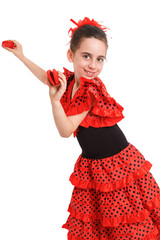 A little girl in a red Spanish dress dances flamenco