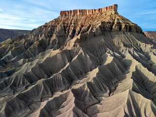 Drone photography of eroded desert badlands. Ridges and canyons of Factory Butte. Moab. Utah. USA