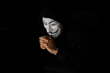 Smiling white criminal anonymous mask as hack programmer trying to approach main data server drive...