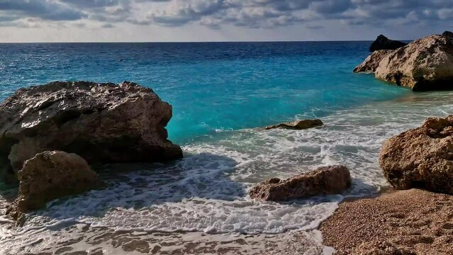 Greece best beaches of Ionian islands. Lefkada - scenic Megali Petra beach with tropical turquoise sea and impressive rocks over sunset. 4k hd video