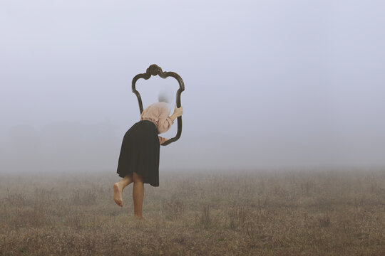 .surreal journey of a woman who escapes from the real world through a frame immersed in fog, abstract concept