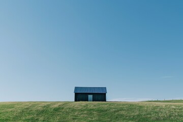 A solitary building stands tall amidst the endless expanse of grasslands, its weathered sign a beacon against the blue sky, a reminder of humanity in the untouched beauty of nature