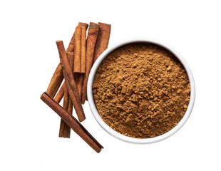 cinnamon sticks and  ceramic bowl with cinnamon powder isolated on a white background, top view.