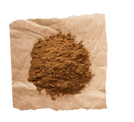 Cinnamon powder on craft paper isolated on white background,top view.