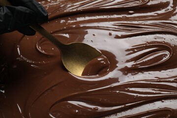 Person making tasty milk chocolate paste, closeup