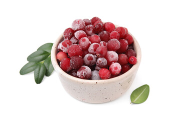 Frozen red cranberries in bowl and green leaves isolated on white