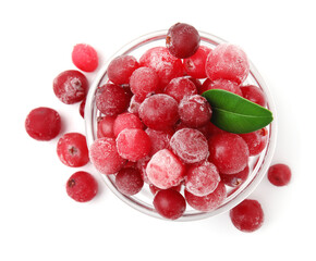 Frozen red cranberries in bowl and green leaf isolated on white, top view