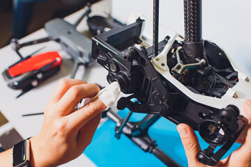 Closeup shot of man working on assembling new surveillance system using quadcopter drone with...