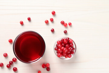 Tasty cranberry juice in glass and fresh berries on white wooden table, flat lay. Space for text