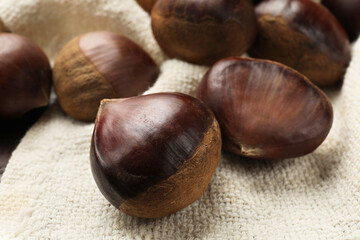 Sweet fresh edible chestnuts on table, closeup