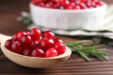 Fresh ripe cranberries on wooden table, closeup