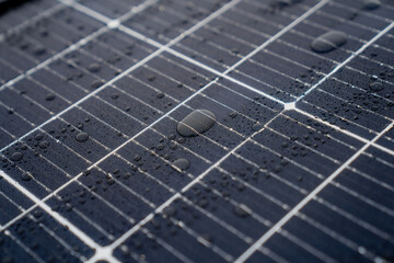 Solar panels close up water sprinkles of fresh rain water on the surface