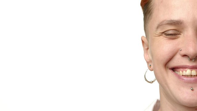 Close-up capture of a beaming lesbian, her face adorned with a stylish piercing, exuding confidence and joy as she proudly showcases her LGBT identity. Camera 8K RAW. . High quality 4k footage