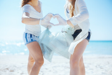 Eco activists collecting trash and showing heart hands