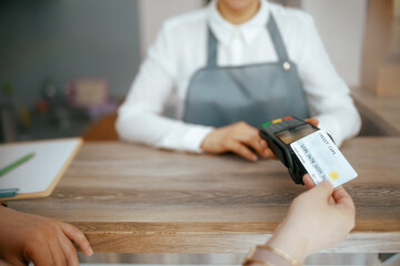 Woman hair salon worker accepting credit card payments