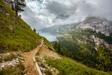 landscape with mountains, Fedaia lake, clouds, forest and trail