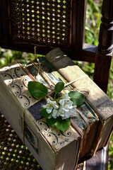 A stack of old books on a chair in the garden, reading books