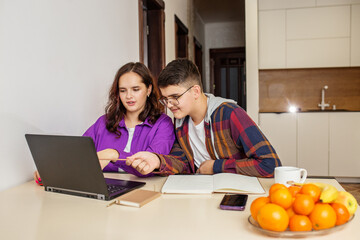 Teenage Students Engaging in Group Study with Laptop