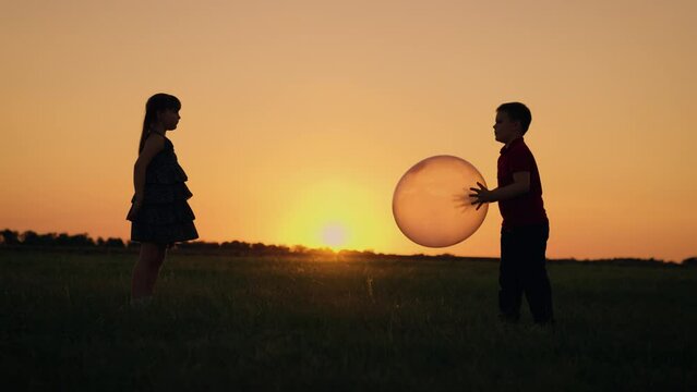 Girl Child Boy Kid playing big ball sunset, children dream flying, happy family, learning cooperate, sparks imagination spending time together, aspirations come true, limitless possibilities hidden