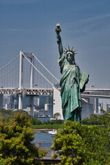 The Statue of Liberty and the Rainbow Bridge in Tokyo Bay.  Tokyo Japan
