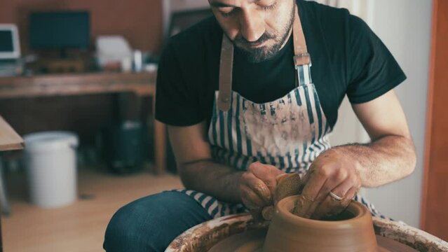 Man, ceramics and pottery studio with worker, craftsmanship and potter in workshop. Small business, creative and expert for arts and crafts for artisan, employee and working on handmade art