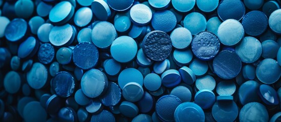 A pile of beautiful blue glass pebbles shining under the sunlight